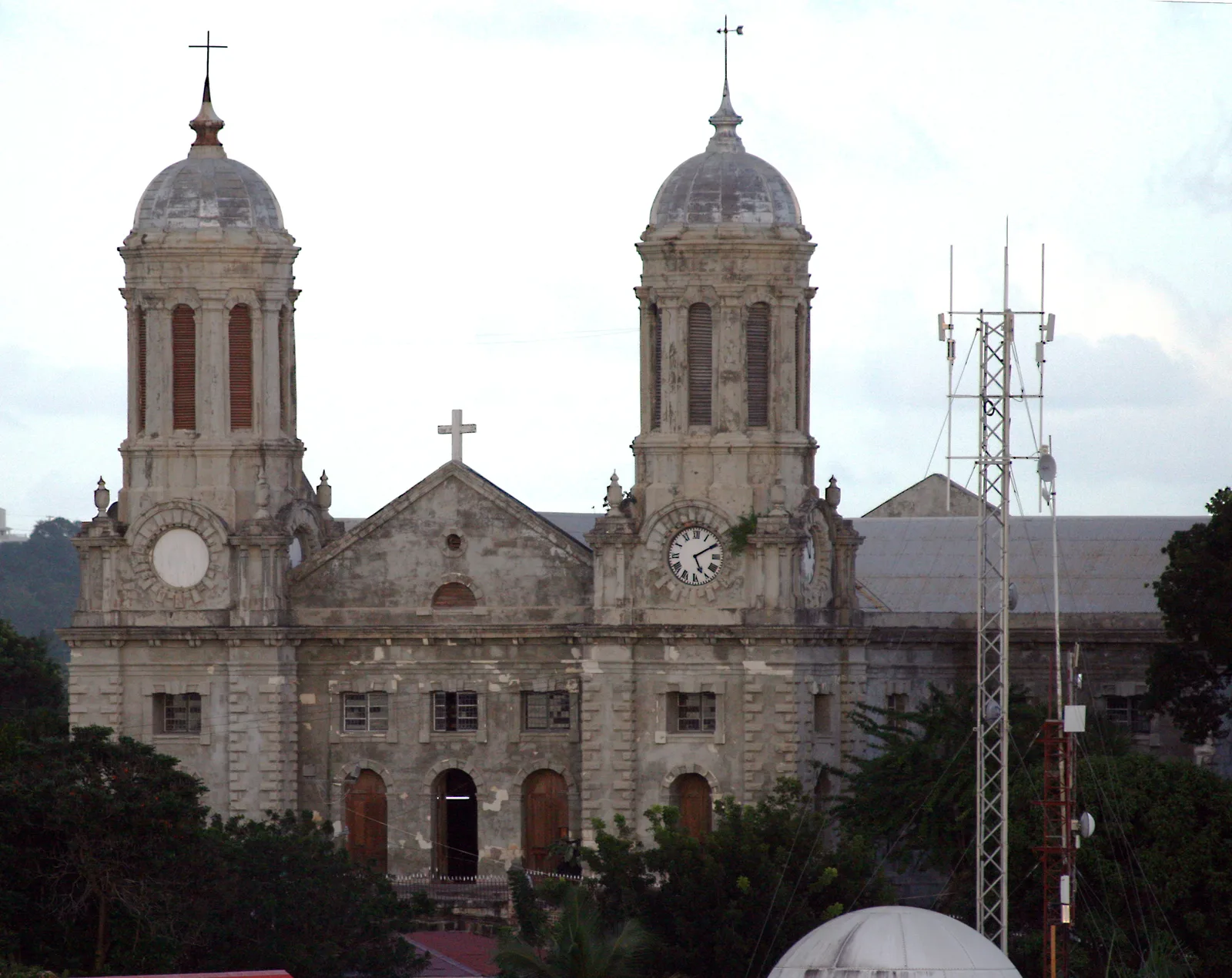 The twin-towered stone facade of St. John's Cathedral in St. John's, Antigua.