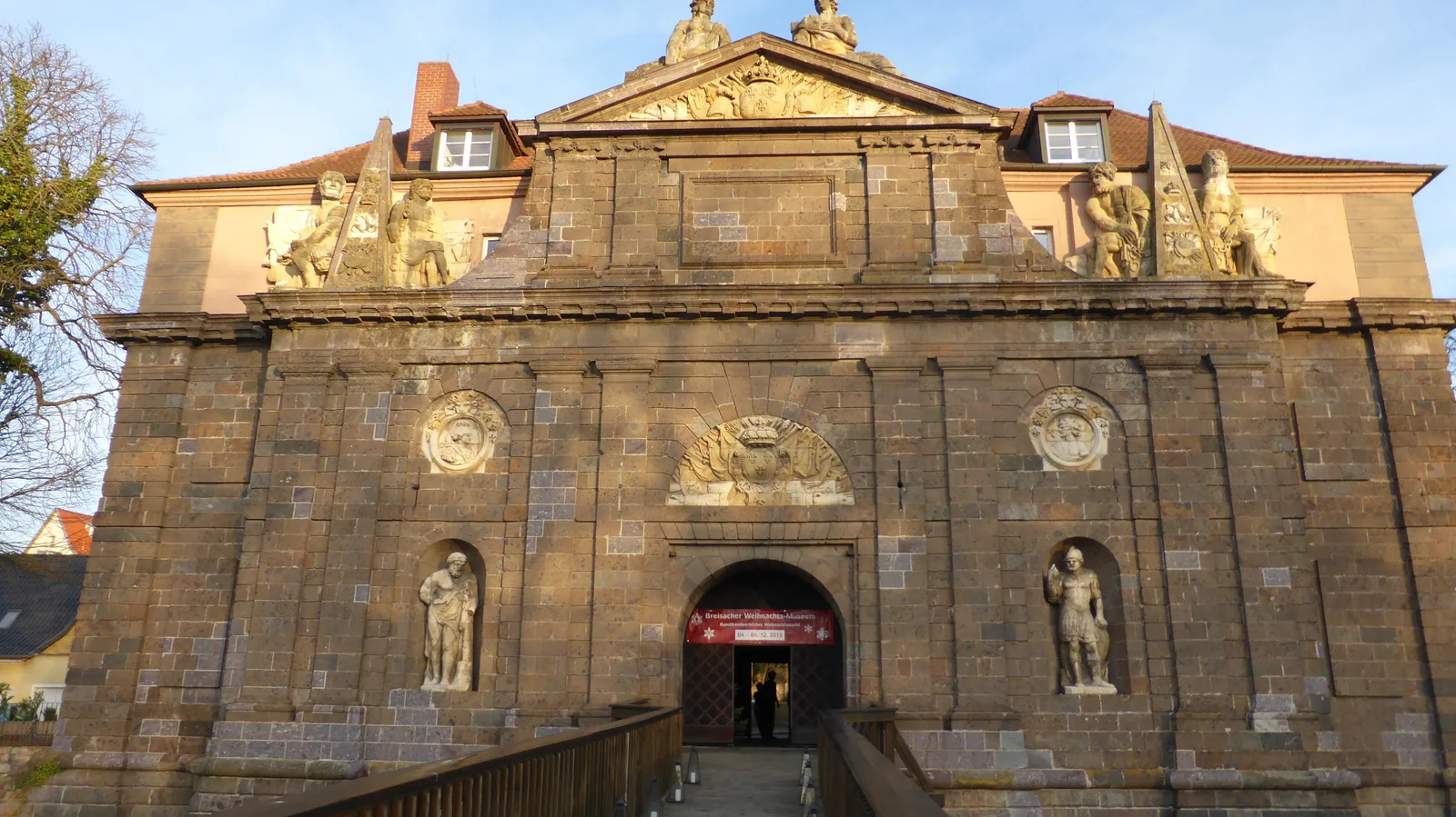 A baroque stone gate building with a carved facade in Breisach, which houses the town museum.