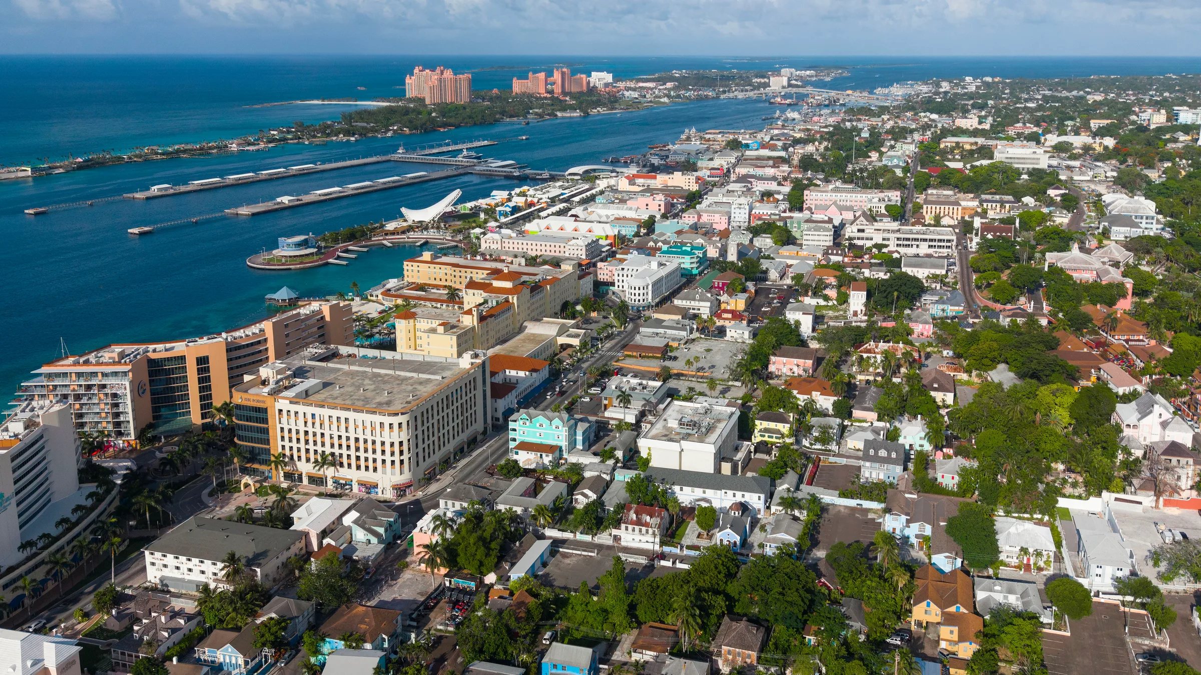 Aerial view over downtown Nassau, its long harbour, cruise piers and Paradise Island across the water.