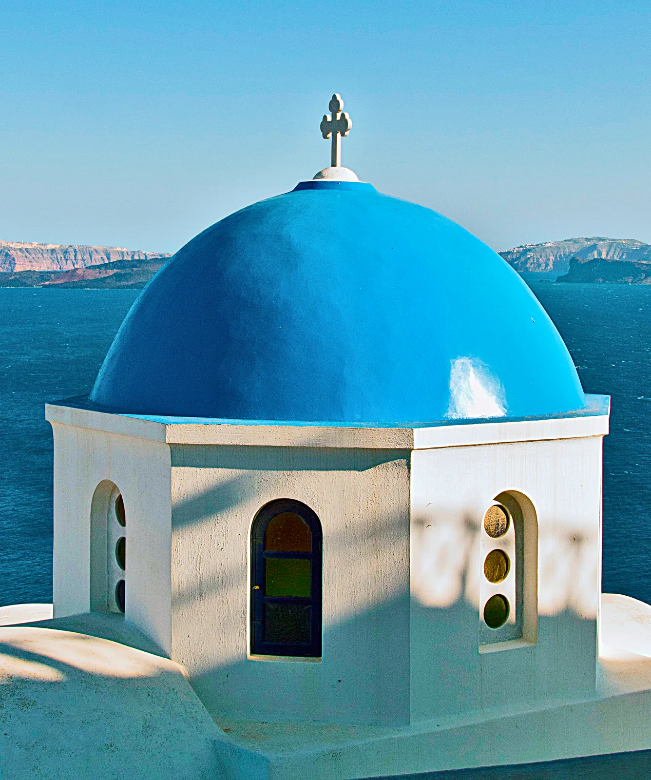 A classic blue dome against whitewashed walls in Oia, Santorini
