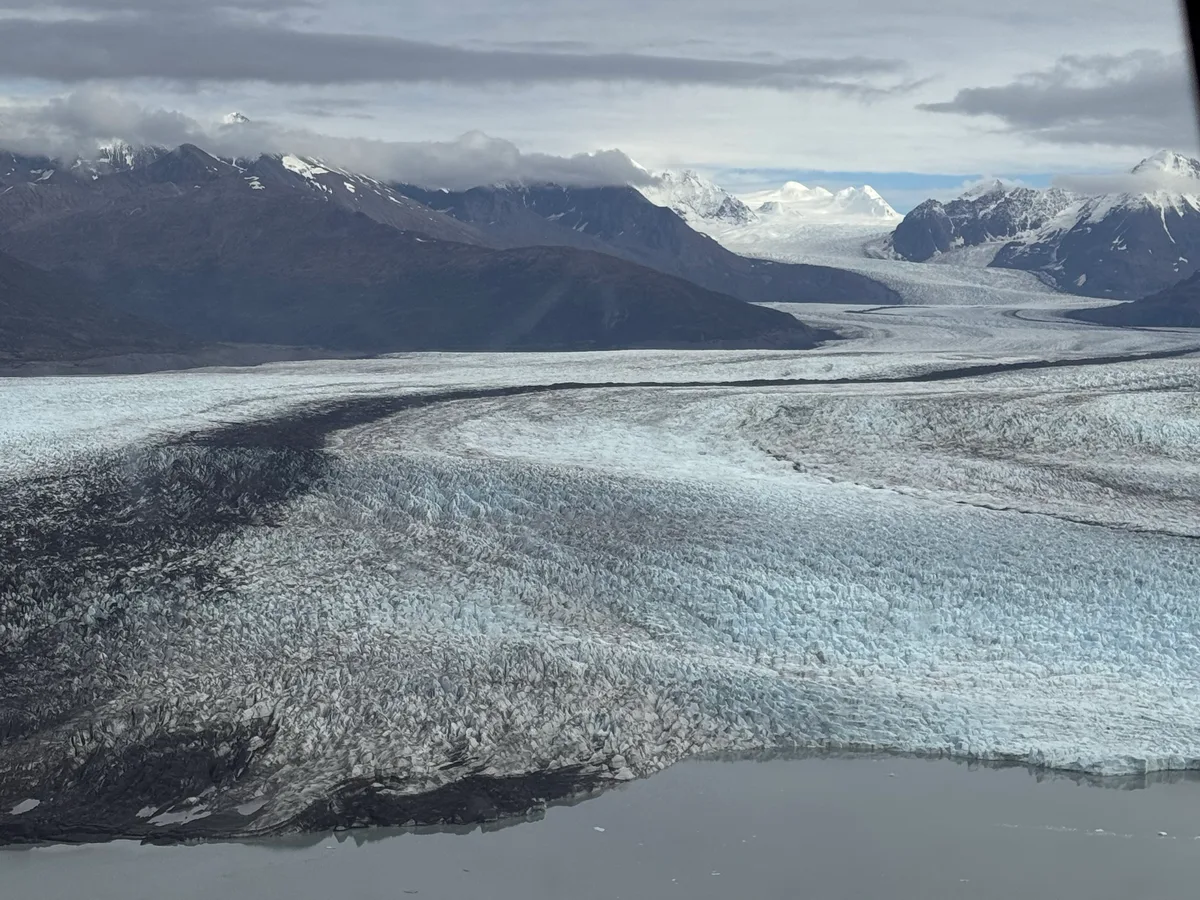 Blue glacial ice and snowcapped mountains near Juneau, Alaska