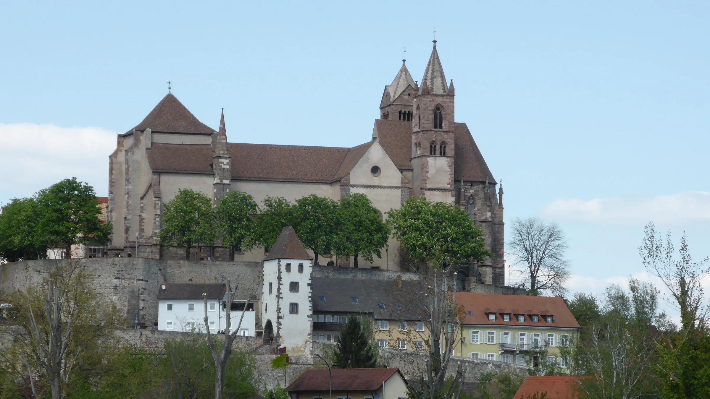 Breisach Minster and the old walls above the town, seen from below in clear weather.