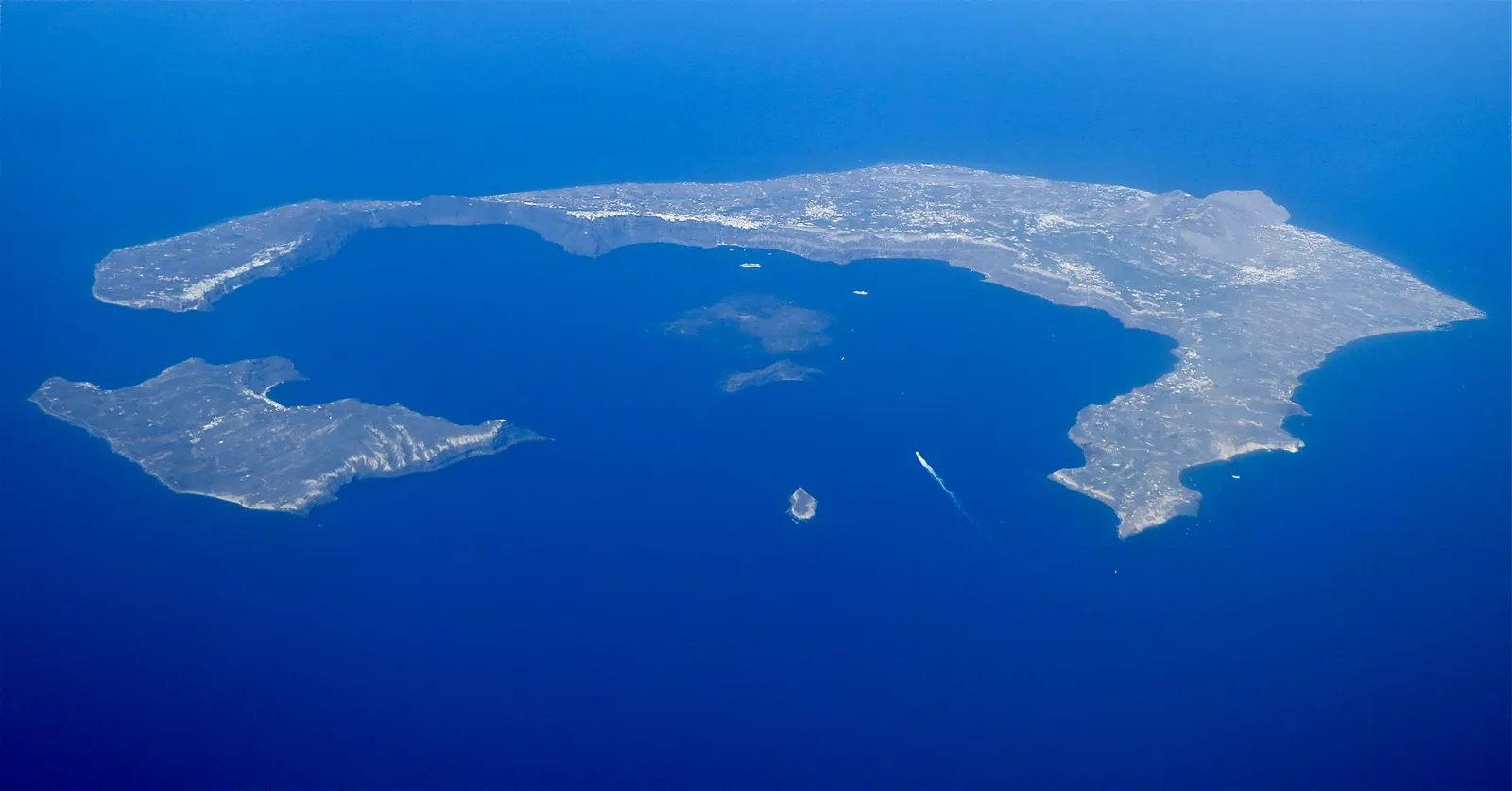The dramatic volcanic caldera of Santorini, cliffs dropping to the deep blue sea