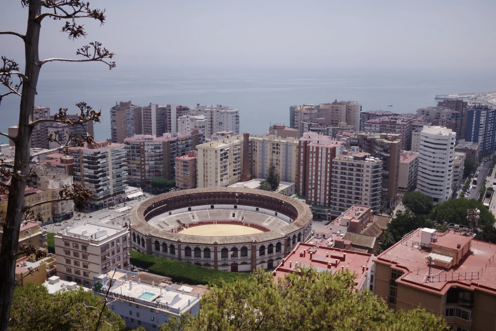 Málaga seen from Gibralfaro hill with the bullring and the harbour and sea beyond.