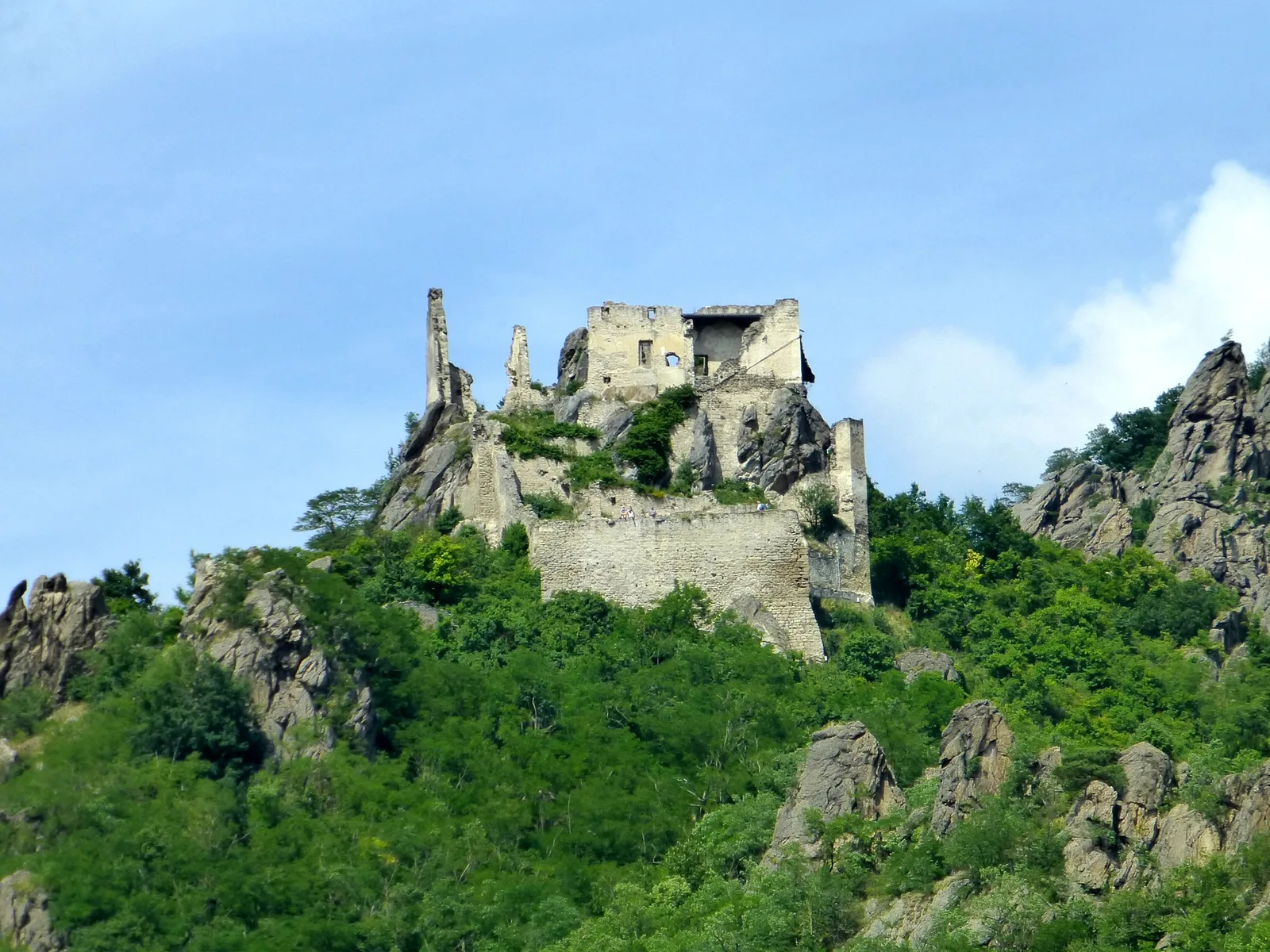 Dürnstein castle ruins on a green hilltop above the forest.