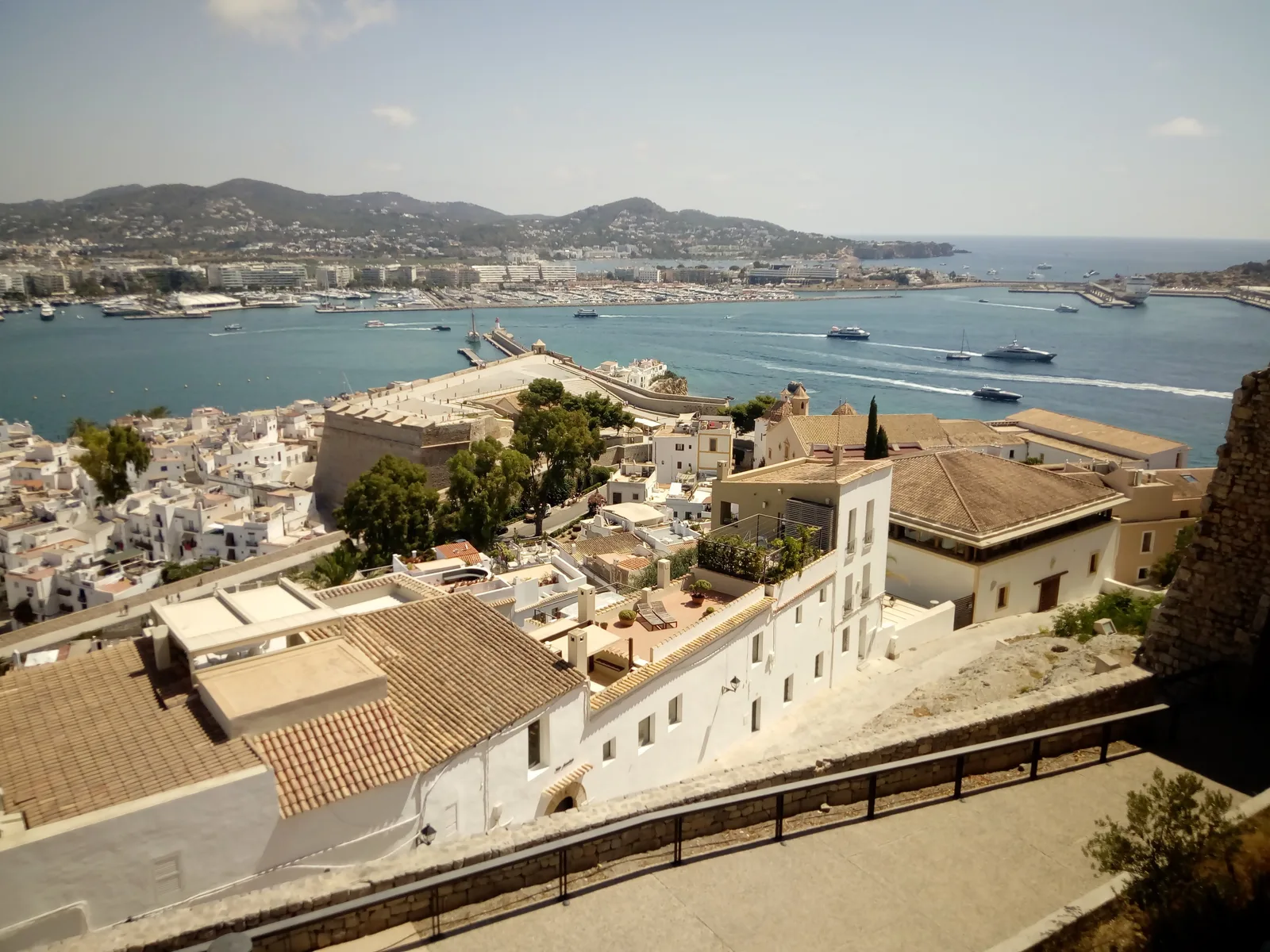 Whitewashed rooftops of Dalt Vila with the harbour and marina below.
