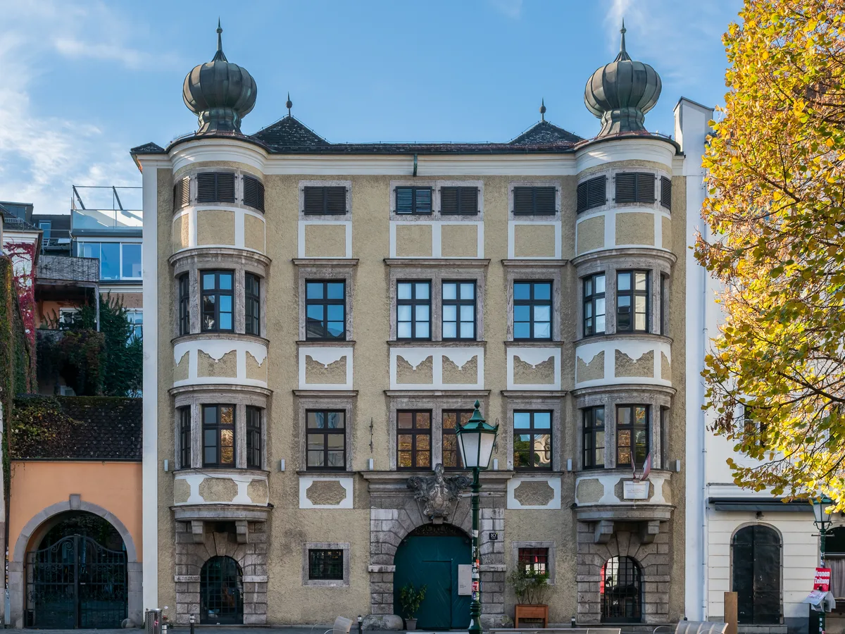 The ornate facade of the building at Altstadt 10 in Linz with onion-domed corner turrets.