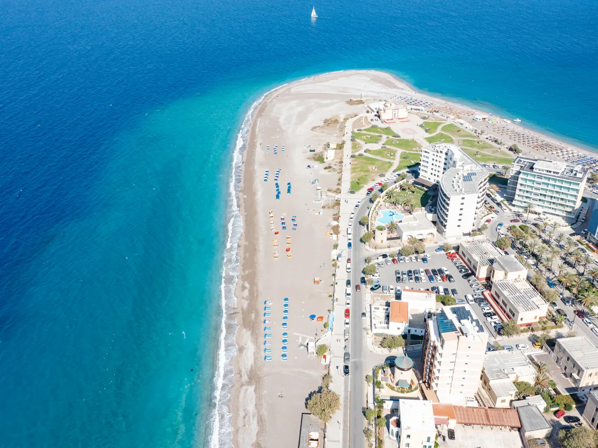 Aerial view along the sandy Elli Beach and Akti Miaouli with seafront hotels and a vivid turquoise sea in Rhodes Town.
