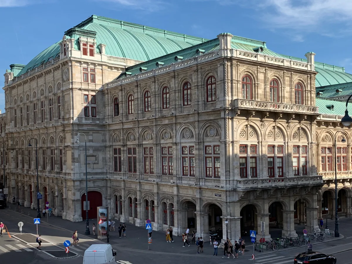 The ornate exterior of the Vienna State Opera seen from a raised viewpoint.