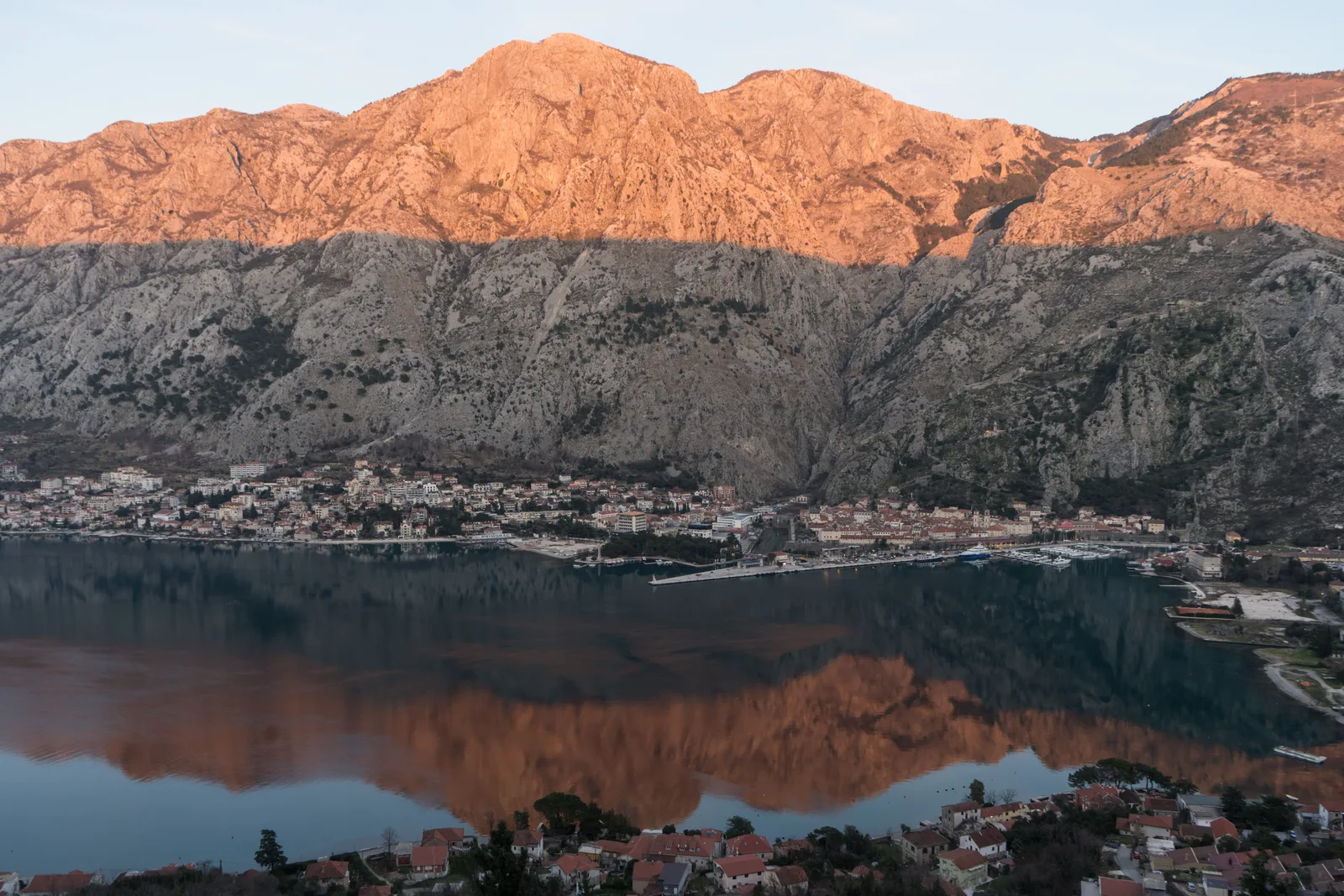Dawn light on the mountains above the Bay of Kotor, perfectly mirrored in the still water.
