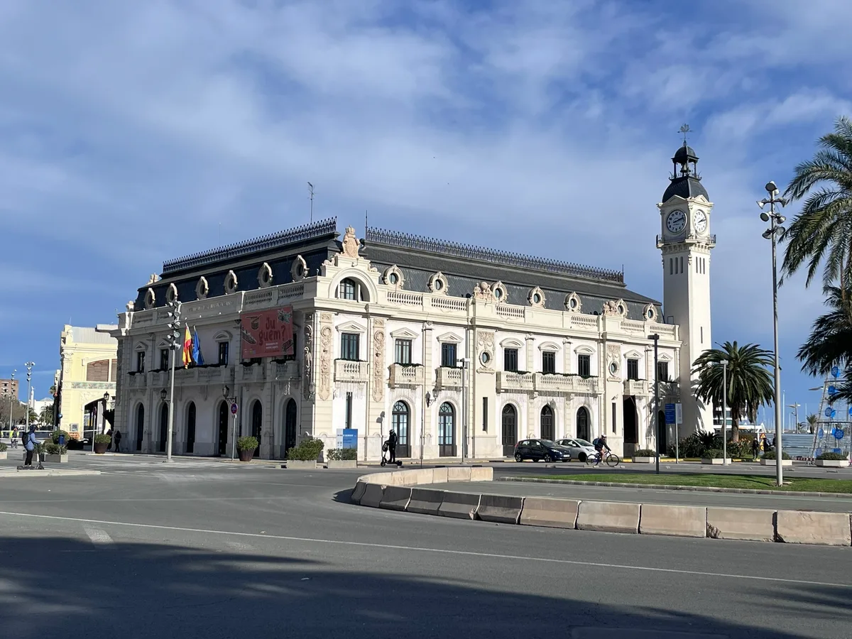 The white Clock Building of the Port of Valencia with its tall clock tower.